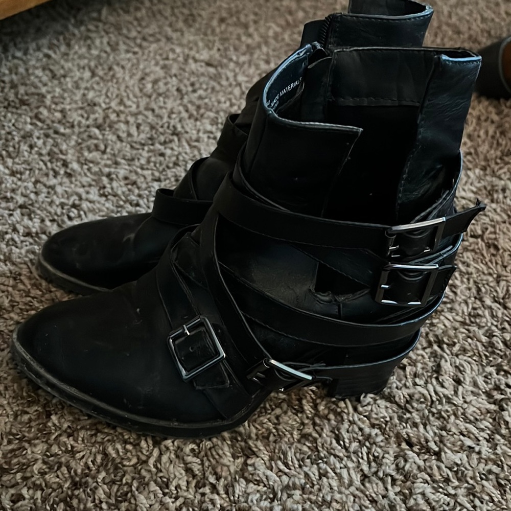 Black heeled boots with straps and buckles